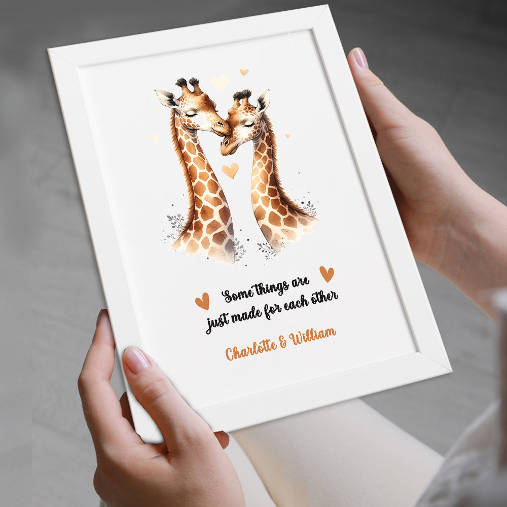 Personalised Giraffes In Love Print in white frame being held