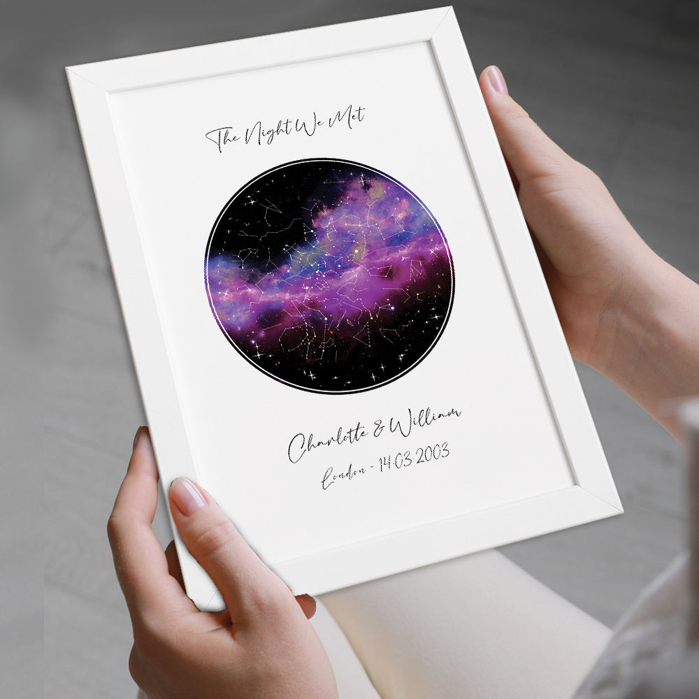 Personalised Star Map Night Sky Print With Black And Pink Background in white frame being held